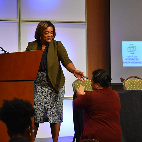 AccessHealth's Renee Linyard-Gary hands Sonia Donnelly a Starbucks giftcard for one of the best tweets of the day using #HealthyTriCounty.