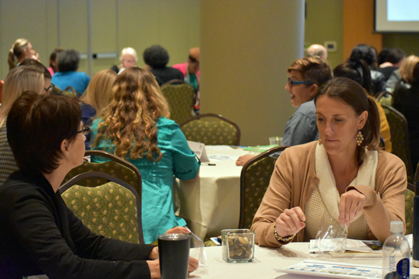 Lyndsey Marchman, Trident United Way and Margaret Peck, Healthy Plate Cooking, take part in a group activity.