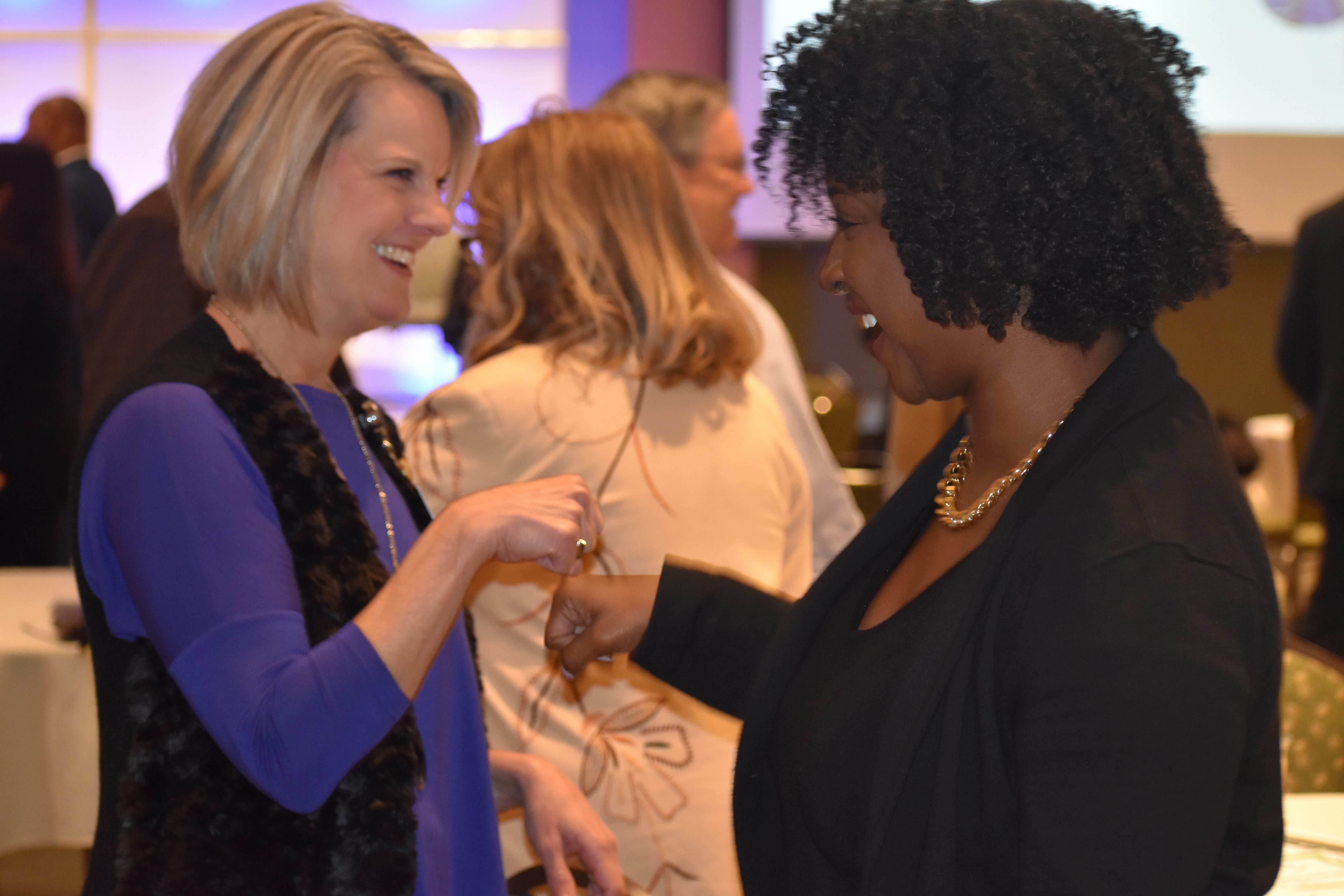 Symposium attendees 'fist-bumping' in support of their pledge to take action with the release of the Tri-County Health Improvement Plan